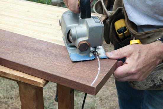 I cut the curved ends with a jigsaw, setting each successive piece in place to mark where the curve of the previous board ended.