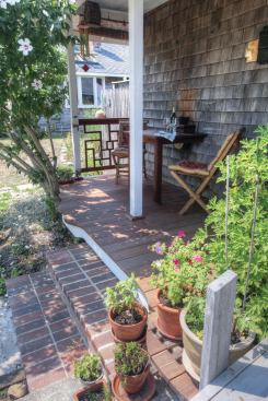 The drop-off on the open end of the porch was so slight that we could forego a guard rail, but I turned some of the flooring scraps into a decorative railing.