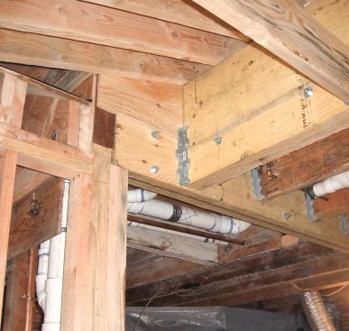 The two new headers intersect near a support post.