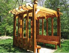 Decorative purlins cast shade on built-in benches in this western red cedar pergola by Custom Outdoor Structures, Dayton, Ohio.