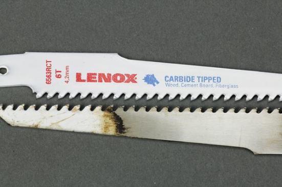 Lenox's carbide-toothed blade may not cut nails, but it's great in abrasive material. The blade at the bottom was still going strong after making 122 cuts through shingles and OSB. The tips were worn but not damaged.