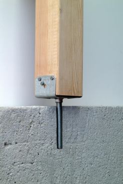 The height on some post bases can be adjusted with a threaded rod that’s cast or epoxied into the footing.
