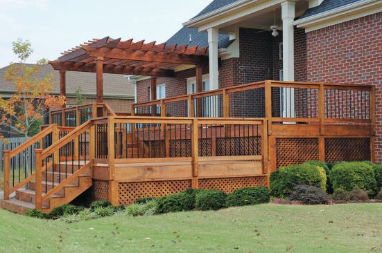 The author sometimes adds landscaping to his deck photos using Photoshop. He copies shrubbery and other details from photos that are similar in lighting and tone, and pastes them on the original photo. The result shows off the deck in a better light.