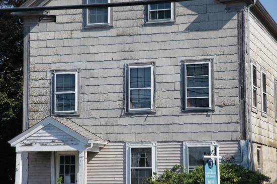 Before the renovation, the building was essentially sound, but the years had not been kind to it. Asbestos shingles covered the walls.