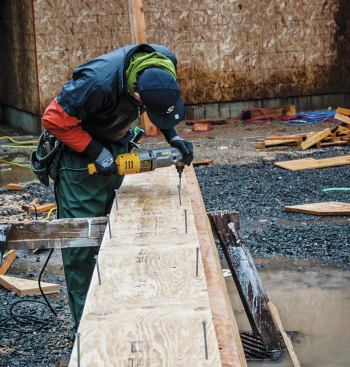 We took the plumb depth for each pitch and ripped two pieces of LVL — one to match the plumb depth of the 8/12 rafters, and one (deeper) piece for the 12/12 side — and screwed them together ...