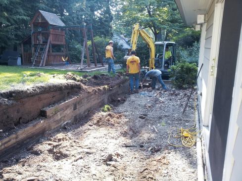 Problems with this job included a sunken backyard, poor drainage, and an old retaining wall that had to go.