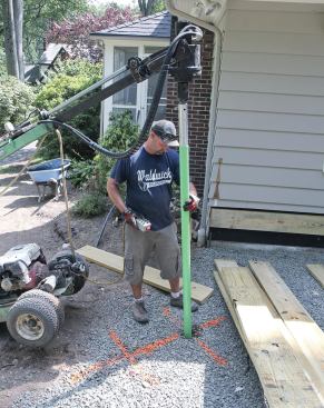 Galvanized steel helical-pile footings were driven to support a drop beam at the stairs.