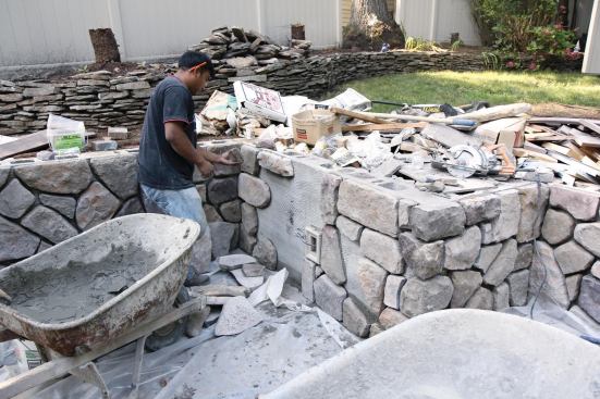 After the decking was complete, cultured stone was applied to the retaining wall.