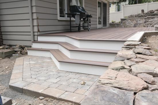 Concrete pavers provide a stair landing and a path to the deck. 