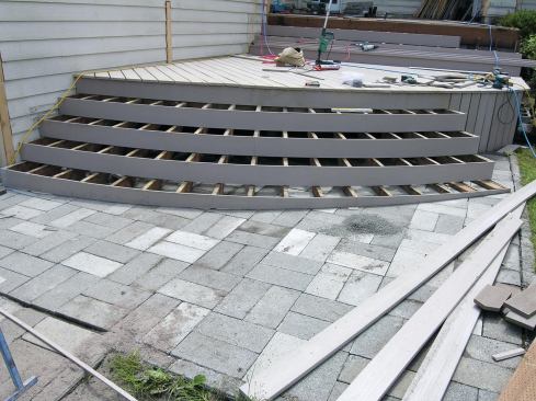 When the ground slopes perpendicular to the jacks, scribe and cut their bottoms to level the stair.