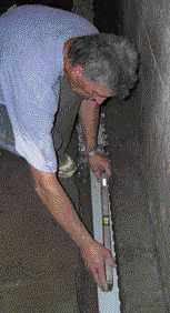 The piping is sloped toward the pump — 1/4 inch over the length of the wall is usually enough.