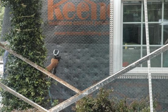 Accessories like window casing beads and control joints go on top of the drainage mat.