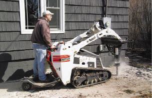 Figure 4. Getting rid of an old concrete slab or stair to make way for a new deck can be backbreaking work. You might compare the cost of renting a machine and a hydraulic hammer with that of a couple of weeks of chiropractic care.