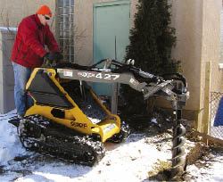 Figure 6. Augering out footing holes may be most deck builders’ favorite use for a subcompact loader. Holes that might take half an hour to dig with a shovel are done in five to seven minutes.