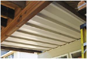 An underdeck drainage system in the ceiling above makes soaking in a hot tub in the rainy Northwest more appealing.