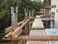 Once all the posts were positioned, a laser was used to mark their heights. Simpson Strong-Tie CC66 column caps (800/999-5099, strongtie.com) were installed to secure the posts to the beams.