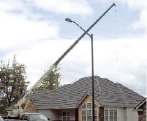 A crane was used to lift the lumber from the street to the deck and set the individual beams on their posts. As the author had no line of sight to the crane operator, the author’s wife operated a radio while he guided the lumber into position.