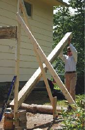 The first joist is run a little long so it can rest on the assistant, while providing space to raise and plumb the post.