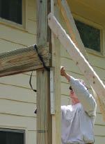 The joist is temporarily secured, and the assistant can be relocated for the next post.