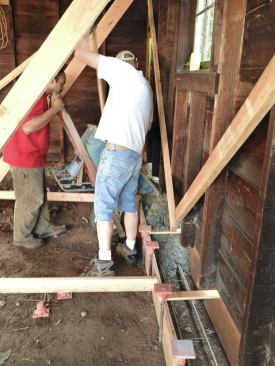 Over a couple of hours, the crew wheelbarrowed the concrete around the bracing to the forms ...