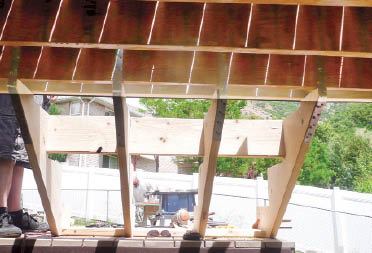 Figure 2. With the jack placed, the strapping is bent upward and nailed to the side of the joist. Use full diameter 10d x 11/2-inch nails for the joist connections.