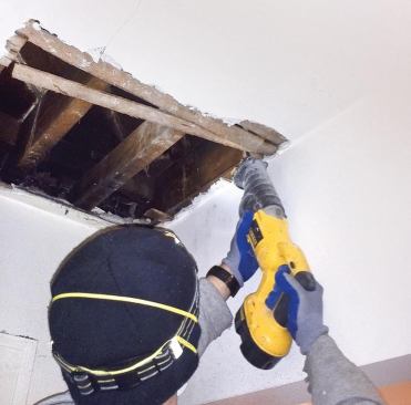 We used a Sawzall to cut through the plaster and wood lath at the junction of wall and ceiling.