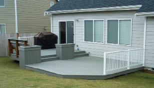 Figure 2. An area for a grill and some built-in planters satisfied both husband and wife. Rails on the higher section protect their youngster from falls.