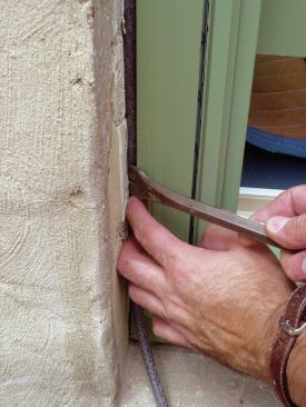 Foam backer rod fills the gap between the trim and the opening. A bead of color-matched caulking completes the seal between the window and the trim, and between the trim and the opening.