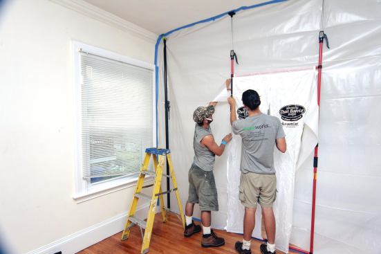 T-shaped cuts are made in the barrier wall behind the door, leaving 3- to 4-inch-wide flaps of plastic remain inside the steel uprights.