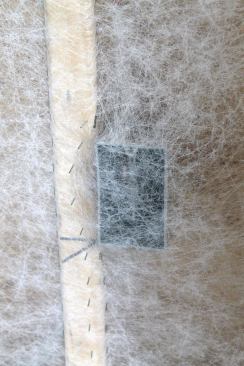 The tension of the netting against electrical boxes is enough to prevent them from filling with insulation when the cavities are packed; the netting will later be cut by the drywall crew.