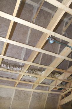 A skilled installer can snugly fit the netting around joists, collar ties, and other obstructions. As long as the material is tight and securely stapled, small gaps won’t leak significant amounts of insulation as the cavities are blown full.