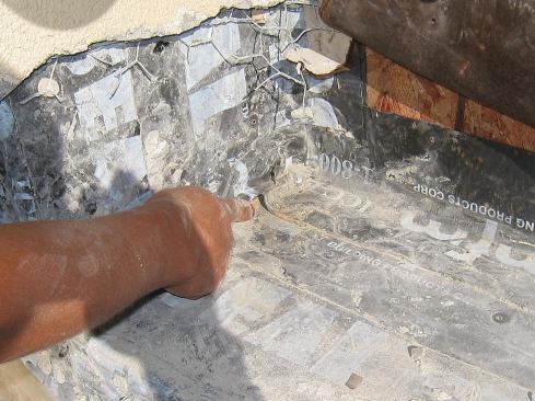 Wrinkles in the membranes can also create water paths underneath stucco, as in the wide sill of this recessed window.