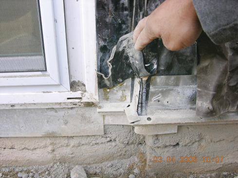 The open slits in the upper leg of this poorly installed weep screed allowed water to soak the framing.