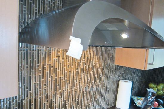 The sharply angled corners of the hood itself have proven to be a liability. There are only two possible solutions — throw the expensive item away and install a different one, or learn to avoid the corners. The home­owners have opted for the second course.