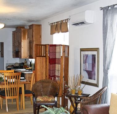 Ductless heat pumps deliver cooled or heated air with one or more indoor fan-coil units. For this home’s single-zone system, the surface-mounted indoor unit has been placed in a central area of the living space to distribute the conditioned air as widely as possible.