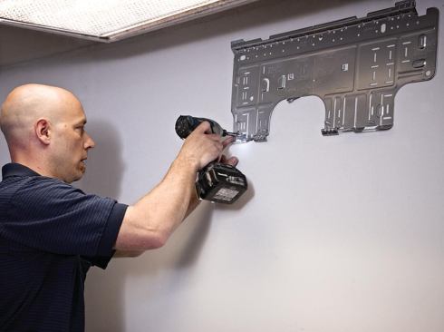 The mounting bracket of a wall-mounted indoor unit is screwed to the studs.