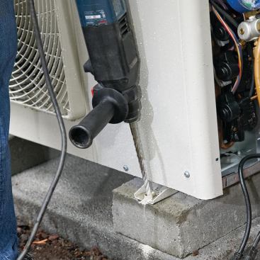 The outdoor unit is fastened to the risers with Tapcon screws.