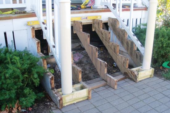 A pressure-treated frame was built to support the new posts and bottom tread.