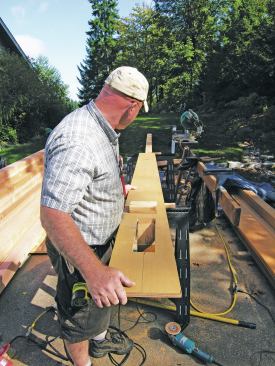 A simple plywood jig makes cutting the rafter tails easier.