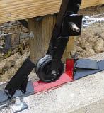 Figure 5. Rollers at the end of the lifting arms travel on tracks made from steel angle. A safety bar placed atop the tracks when the hatch is raised prevents it falling should the cable fail.