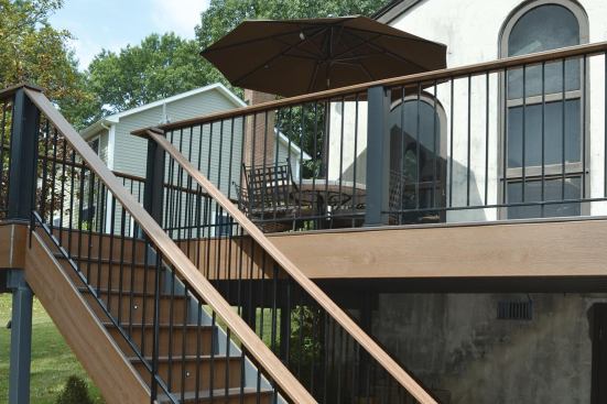 Attach a deck board to a low-profile metal railing as a cap to give the owners and their guests a surface to put cups and other items on.