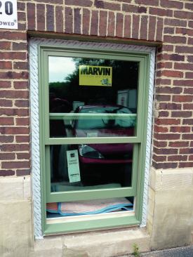 The sill is not flashed to provide a drainage path, but the head flashing overlaps the side flashing to complete the weather seal of the window.