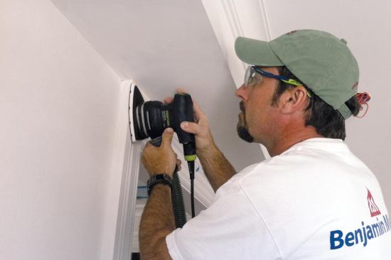 Waterborne primers raise the grain, so once the primer has dried, he sands it with 150- to 180-grit paper to smooth out the surface. and prepare it for top-coating.