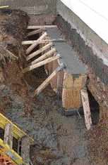 The side of the excavation underneath the existing footing provided the back wall for the poured concrete.