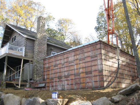 The foundation forms tower 12 feet above grade at the back of the garage.