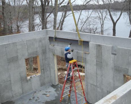 I-beams provide midspan support for the garage floor. A header beam spans the door opening at the rear of the building.