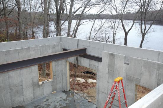 The header beam above the door supports one of the I-beams under the garage floor slab.