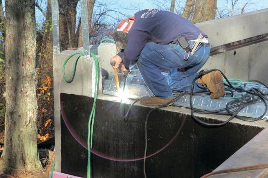 A welder then spot-welds the pans to the perimeter angle iron.