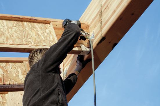 If we are using hangers, in which case it is best to also install all the hangers on the I-joists while the rafters are still on the ground. That way, as the framer at the ridge installs each rafter, he just has to nail the hanger to the ridge.