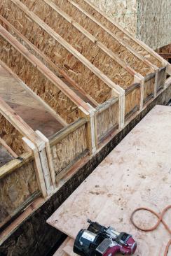 We cut eaves blocking from I-joist stock. Whenever possible, we like to install it as we go when setting the rafters, just like we do when setting trusses.